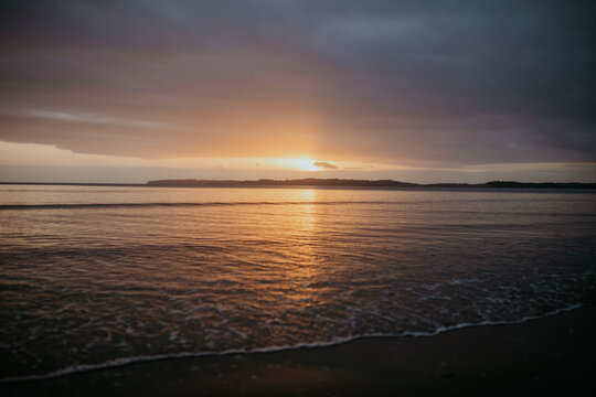 Golden sunrise at Orewa Beach in New Zealand
