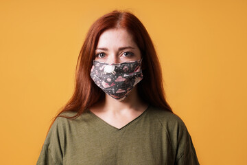 young woman wearing homemade everyday cloth face mask or community mask - covid-19 corona virus pandemic hygiene concept