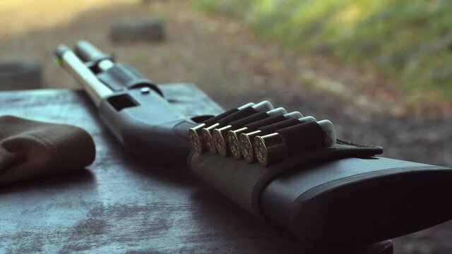 Hunting rifle and bullets. Shotgun. Close-up. Sport shooting from a gun in a shooting range.
