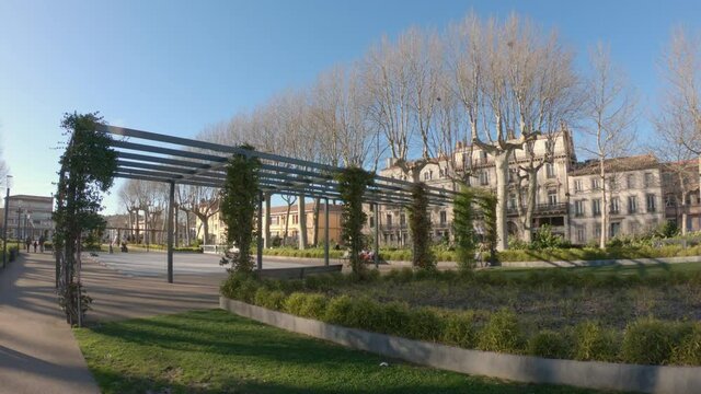 Carcassonne / France - March 11, 2020: DOLLY SHOT - The bronze sculptures of the Catalan artist Marta Solsona adorn the flowered alleys of Square Gambetta.