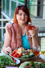 A young woman drinks wine