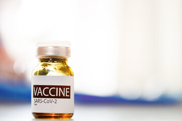 Vial of Covid-19 coronavirus vaccine on table in medical lab