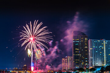 Firework display for celebration happy new year and merry christmas with Twilight night and firework lighting in bangkok cityscape, Thailand.