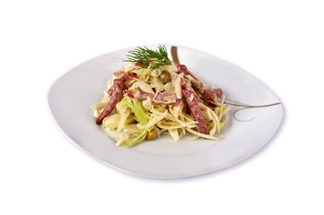 Fresh cabbage salad, green canned peas and cut into strips of servellat , seasoned with mayonnaise sauce isolated on a white background