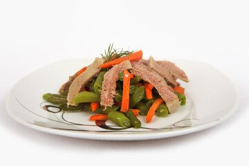 Green asparagus bean salad with boiled tongue on a plate isolated on white background.Selective focus