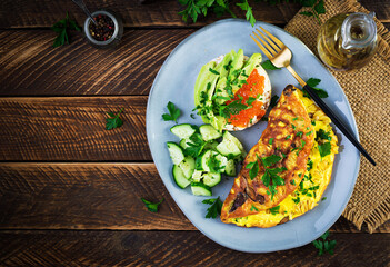 Omelette with forest mushroom, fusilli pasta and sandwich wich red caviar, avocado on plate.  Frittata - italian omelet. Top view, overhead, copy space