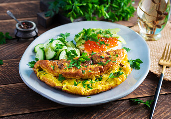 Omelette with forest mushroom, fusilli pasta and sandwich wich red caviar, avocado on plate.  Frittata - italian omelet.