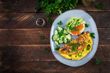 Omelette with forest mushroom, fusilli pasta and sandwich wich red cavier, avocado on plate.  Frittata - italian omelet. Top view, overhead, copy space