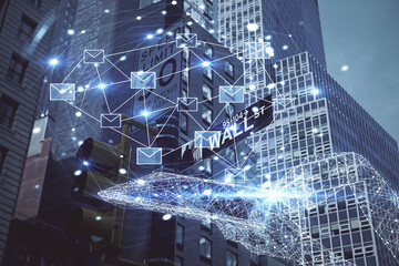 Double exposure of envelop hologram flying from gadget and city view background. Concept e-mail.
