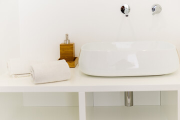Fototapeta na wymiar Ceramic Water tap sink with faucet with soap and towel in expensive loft bathroom or kitchen