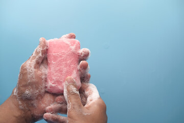 young man washing hands with soap warm water 
