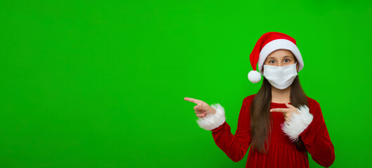A girl with dark hair dressed as a miss claus in a Santa hat points her finger towards the place...