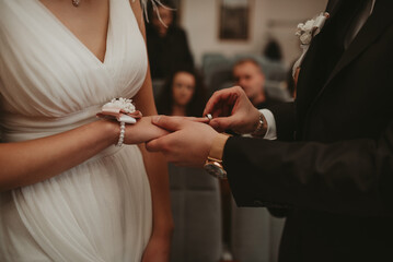 Obraz na płótnie Canvas Groom Put on Wedding Ring Bride Hand