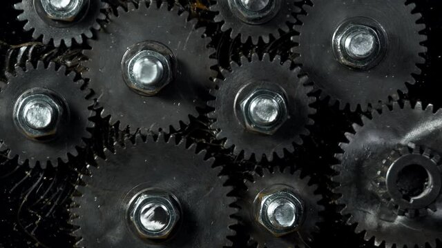 Super slow motion of rotating engine steel wheels with oil splashes. Filmed on high speed cinema camera, 1000 fps.