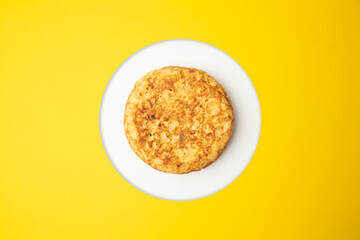 omelette with potatoes on yellow background