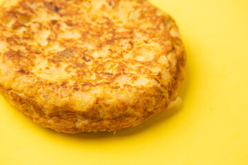 omelette with potatoes on yellow background