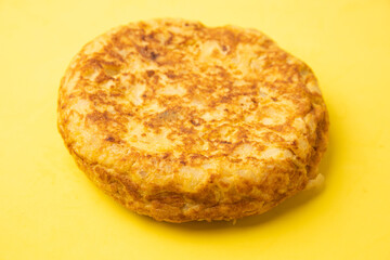 omelette with potatoes on yellow background