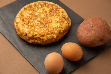 omelette with potatoes on brown background