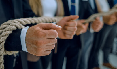 fists of businessmen, trying to get rid of ropes