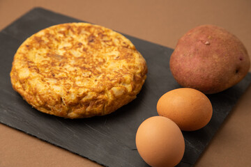 omelette with potatoes on brown background