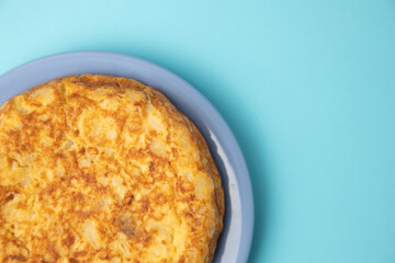 omelette with potatoes on blue background