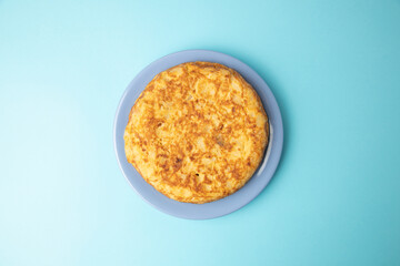 omelette with potatoes on blue background