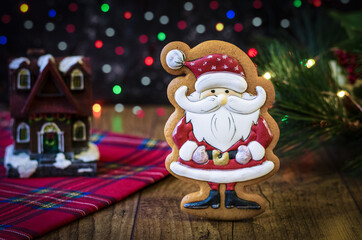christmas cookies on wooden brown background with lights