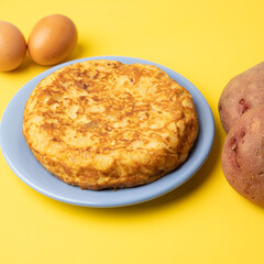 omelette with potatoes on yellow background