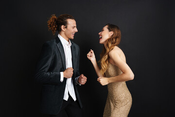 Attractive smiling young couple celebrating