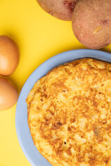omelette with potatoes on yellow background