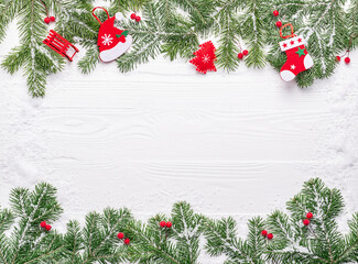 Fototapeta na wymiar New Year background with green branches with Christmas decorations. Flat lay