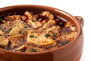 Traditional mondongo or el menudo soup isolated on white background. Close up