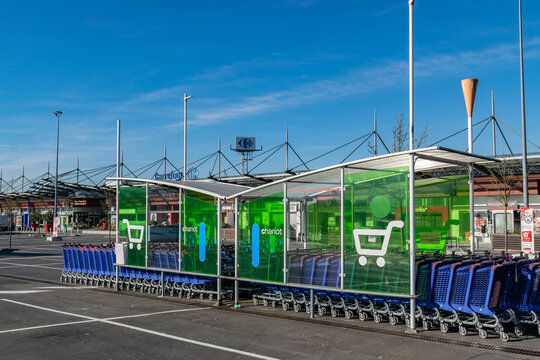 Wasquehal,FRANCE-February 24,2019:Shopping trolleys, parking lot and Carrefour supermarket building.Carrefour is an international French network of hypermarkets and supermarkets,founded in 1959.
