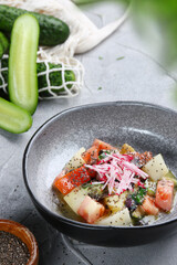 salmon ceviche with onion, cucumber and tomatoes closeup.