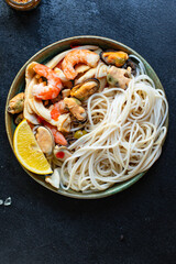 rice noodles seafood cellophane pasta shrimp, mussels, squid ingredient for preparing healthy meal snack top view copy space for text food background rustic