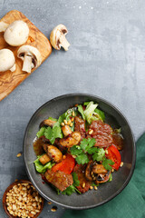 beef and champignons with pine nuts top view. beef and mushrooms salad on concrete table