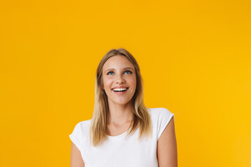 Cheerful beautiful girl smiling and looking upward