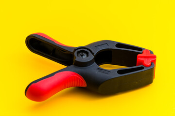 Obraz premium close-up photo of a clamp isolated on a yellow background