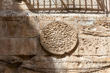 Decorative  pattern carved in stone on the wall in the Muslim part of the old city of Jerusalem in Israel