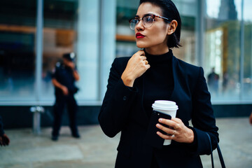 Elegant and successful woman standing on street