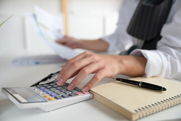 Hand of Businessman using calculator calculate expenses monthly bill