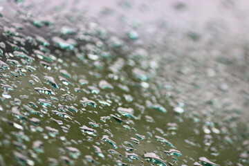 Raindrops on the glass of the car. Selective focus.