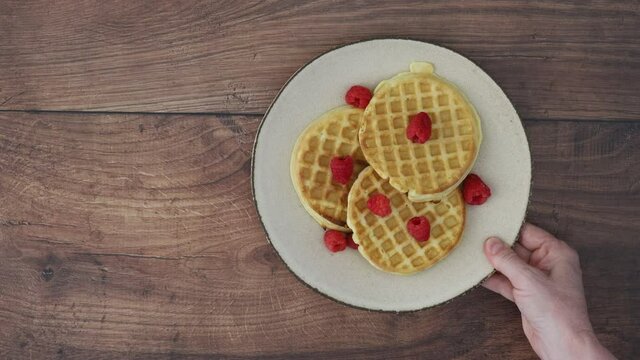 Serving Raspberry Waffles on a Wooden Table
