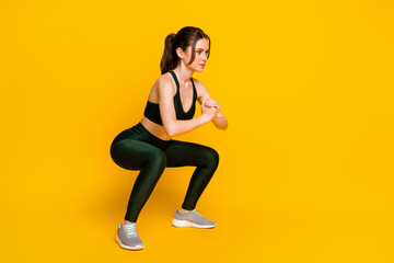 Full length body size profile side view of her she nice focused sportive girl doing sit-ups practicing isolated on bright yellow color background