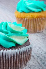 Two homemade muffin with blue butter cream