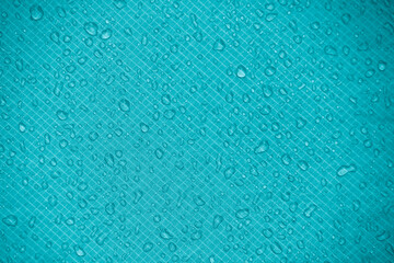 Water-repellent fabric in large raindrops. Sea blue rip-stop fabric. Tent textiles. Waterproof material.