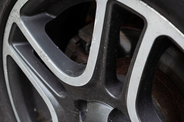 Wheel rim with scratches and dirt.