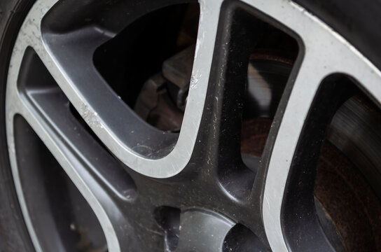 Wheel rim with scratches and dirt.