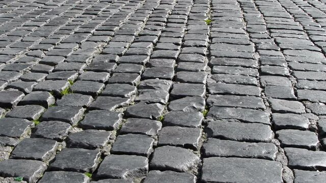 Old and empty street with cubic blocks of porphyry. Typical flooring of in some streets of Italy &ndash; Realtime 4K

