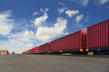Obraz premium Cargo train platform with freight train Containers on the train on crane loading in port background.